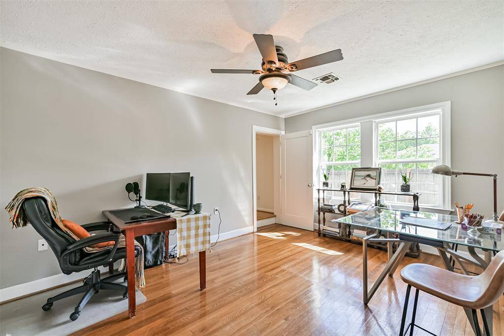 Currently used as a cozy office, this third bedroom serves as the bridge between the original home and the 2016 addition. With a door leading into the addition, you can easily choose to keep the spaces connected or create more privacy between the two areas.  Should you choose to lock the door, you'd access the addition through the lovely covered porch.
