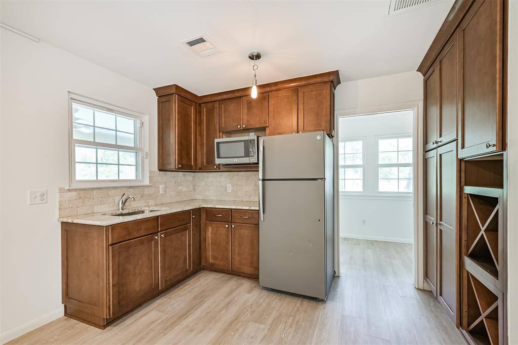The perfect complement to the gameroom, this kitchenette makes entertaining a breeze! With granite countertops, stainless steel appliances, and a built-in wine rack, everything you need—snacks, cold drinks, or wine—is right at your fingertips. If you decide to use this space as quarters or for multi-generational living, having this kitchen is also a huge bonus.