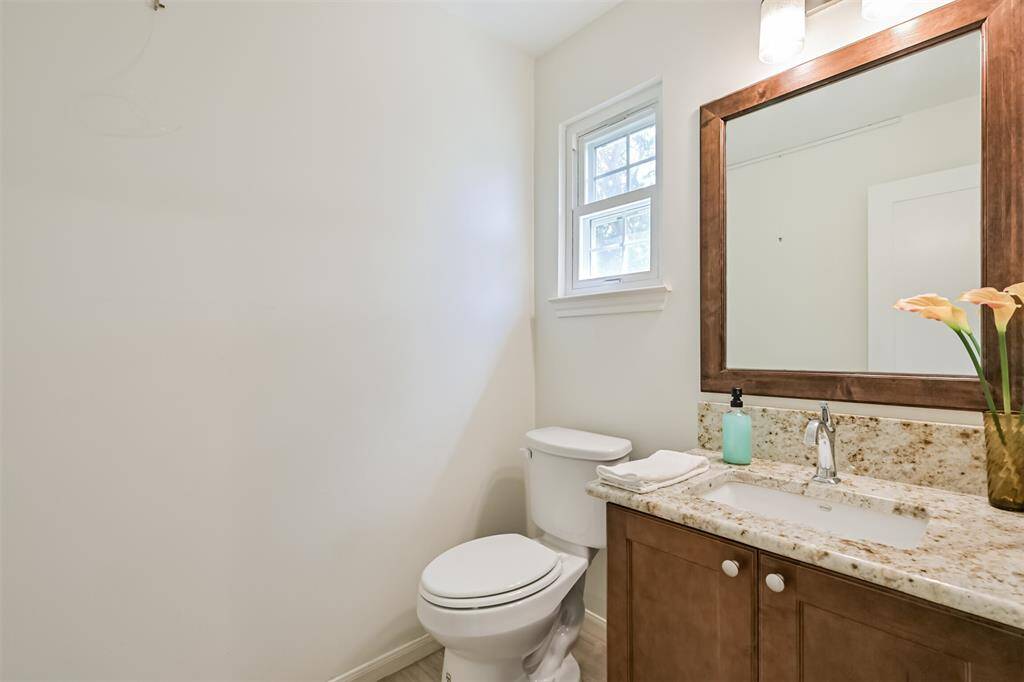 This convenient half bath is perfectly situated to serve the spacious gameroom—ideal for guests and everyday use without needing to head upstairs or across the house.