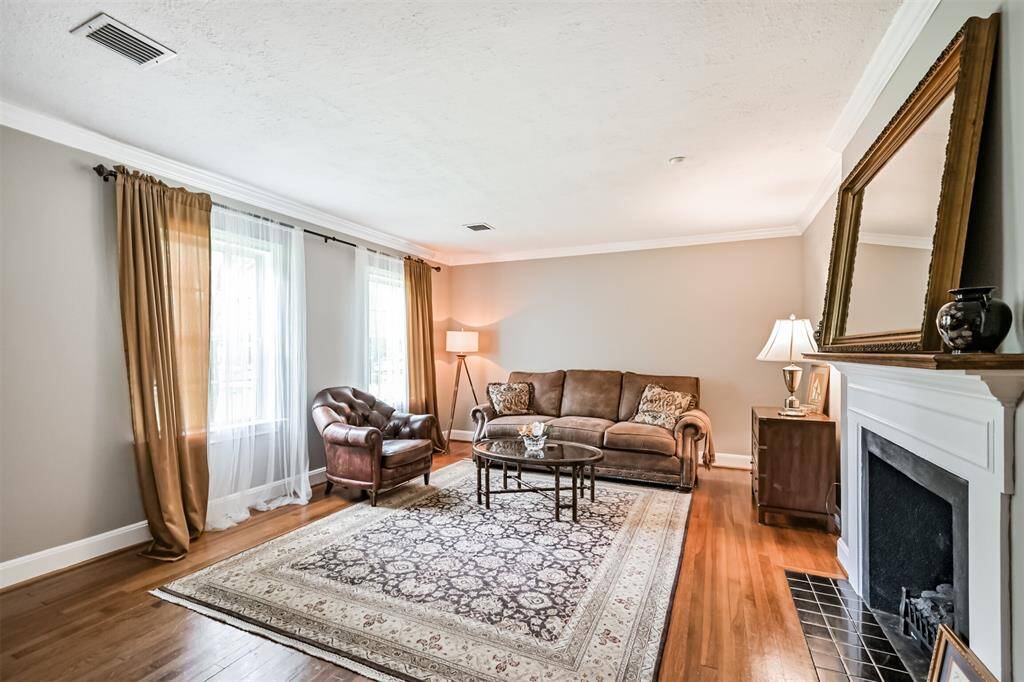 Freshly painted with elegant crown molding and sun-filled windows overlooking the front yard, this front living room blends classic style with a bright, refreshed feel.
