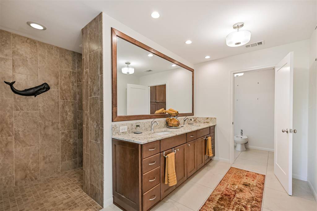 A second look at the luxurious primary bath reveals the thoughtful layout—from the spacious walk-in shower to the elegant double sinks and private water closet. Every detail was designed with comfort and function in mind.