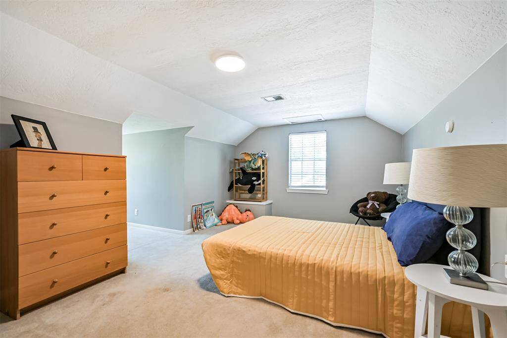 This oversized bedroom is full of potential with unique nooks perfect for customizing your space. Large windows fill the room with light, making it the perfect retreat—private and separate from the rest of the home.