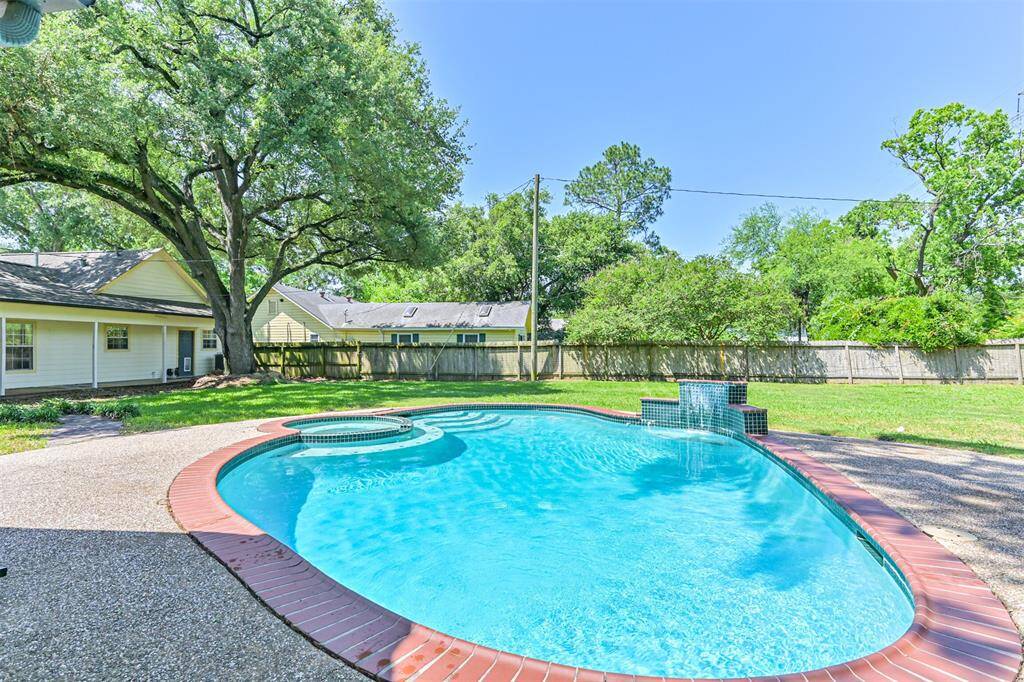 This pool features a lovely waterfall, currently set on a timer, creating a peaceful ambiance. Imagine stepping outside, hearing the soothing sound of the water flowing, and enjoying a refreshing evening swim—truly a serene way to unwind.