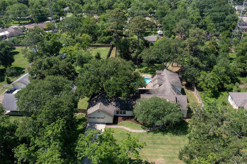Captured beautifully by drone, this view reveals the full scope of what makes this property so special—a stunning home nestled on a sprawling lot with mature trees, a sparkling in-ground pool, and ample space to create your own personal retreat. From backyard gatherings to peaceful mornings, the possibilities here are truly endless.