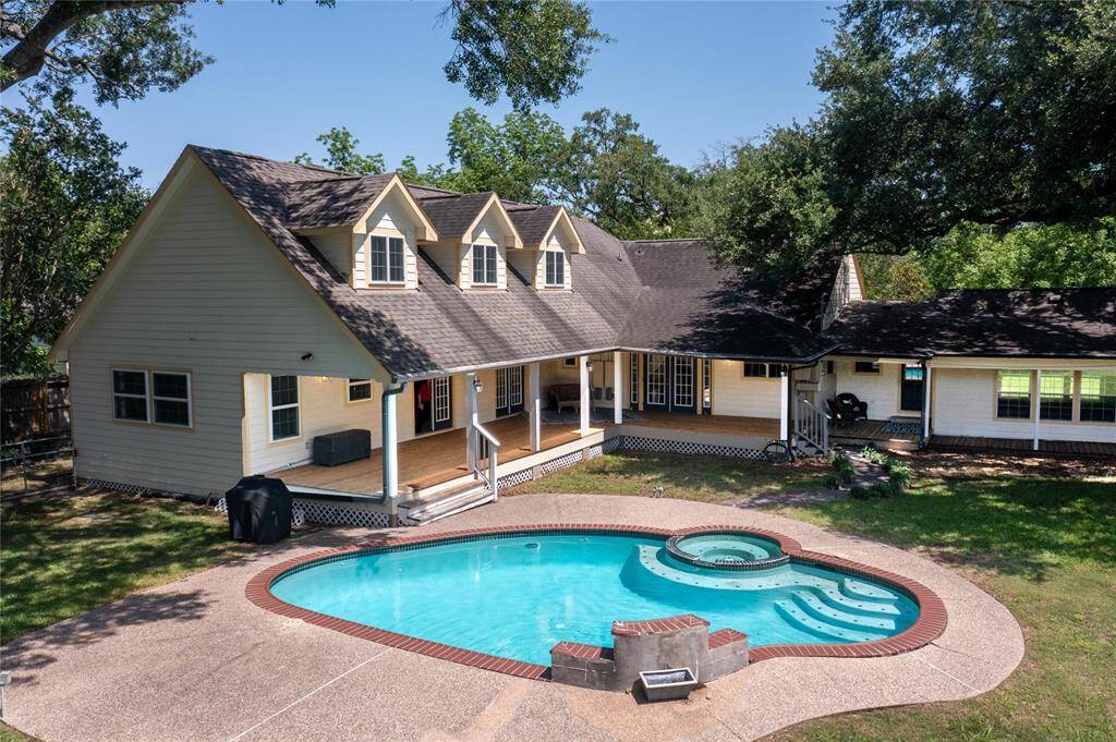 The sparkling pool takes center stage alongside the quintessential covered back porch and the beautiful, expanded home beyond—an entertainer’s dream. Just out of sight, a fenced side area offers endless possibilities: a dog run, chicken coop, private garden, or gated workspace—flexible space to fit your lifestyle.