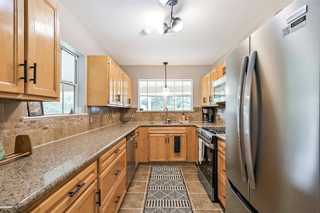 With ample cabinetry, generous drawer space, and sleek finishes throughout, this kitchen blends form and function for everyday living.