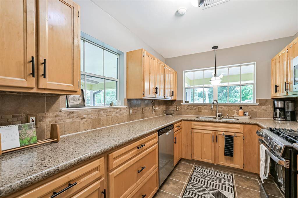 Bathed in natural light from two large windows, this kitchen blurs the line between indoors and out—letting you soak in backyard views. It’s a space that feels as joyful as it is functional.