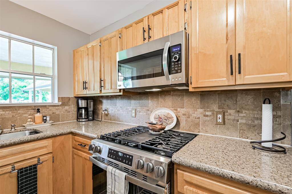 Enjoy cooking with stainless steel appliances—including a gas range, built-in microwave, and refrigerator—all recently replaced to offer both style and performance.