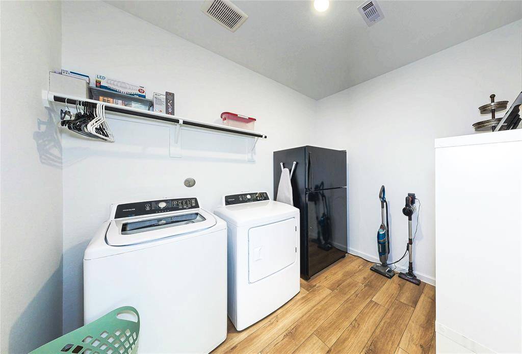 Laundry Room is large enough to hold a full sized washer/dryer, refrigerator/freezer, and additional storage shelves.