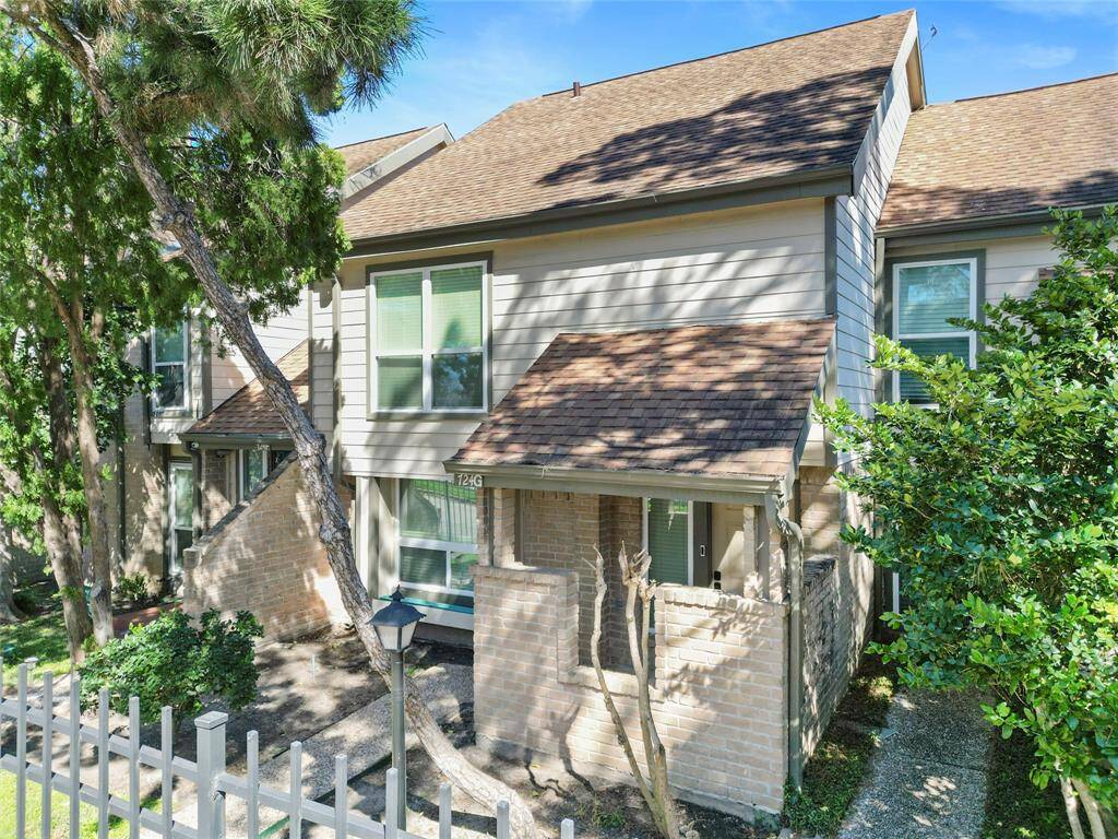Looking back to the front of your charming two-story townhouse, you'll notice a welcoming pathway leading to the entrance, surrounded by greenery for added privacy. This inviting setting is ideal for buyers seeking a cozy and peaceful atmosphere.