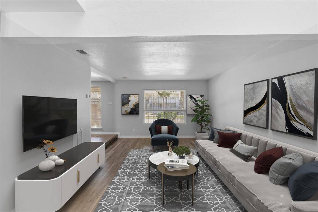 Enter your bright and open living room, a comfortable space perfect for both relaxation and gatherings. Natural light fills the room, enhancing its airy feel, while your wood-like flooring adds warmth and character to the space.