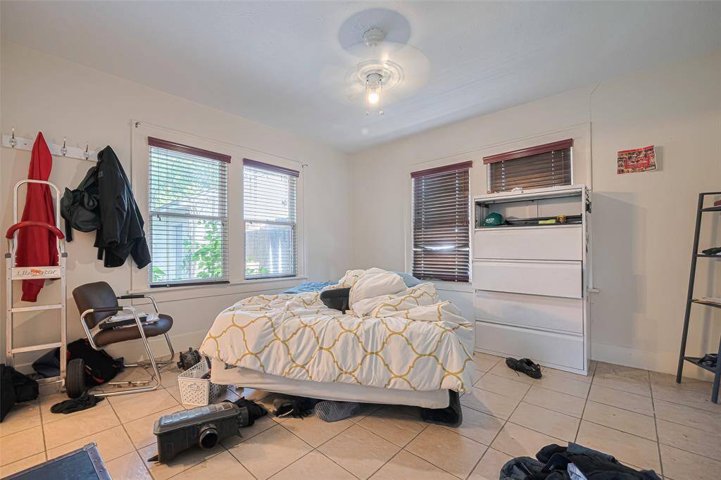 Primary bedroom has tile flooring and 2 walk in closets!