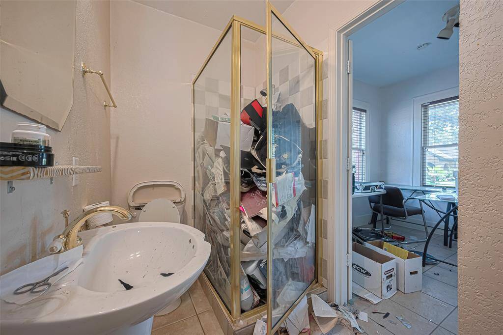 Second bathroom has shower and pedestal sink