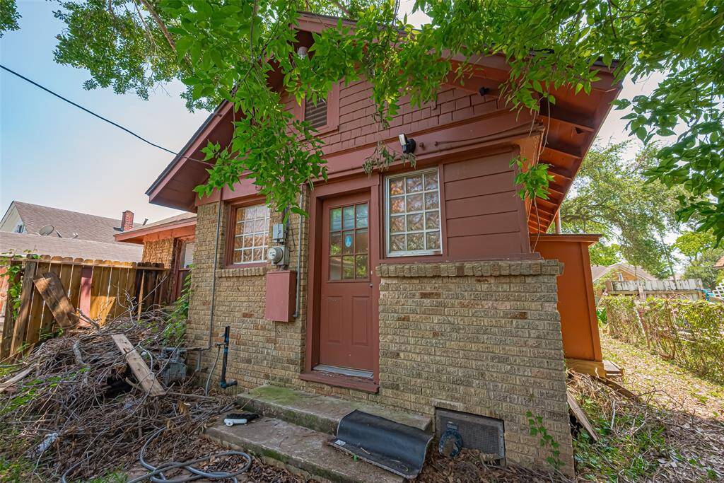 Back door of home with shake style wood accents and glass block windows
