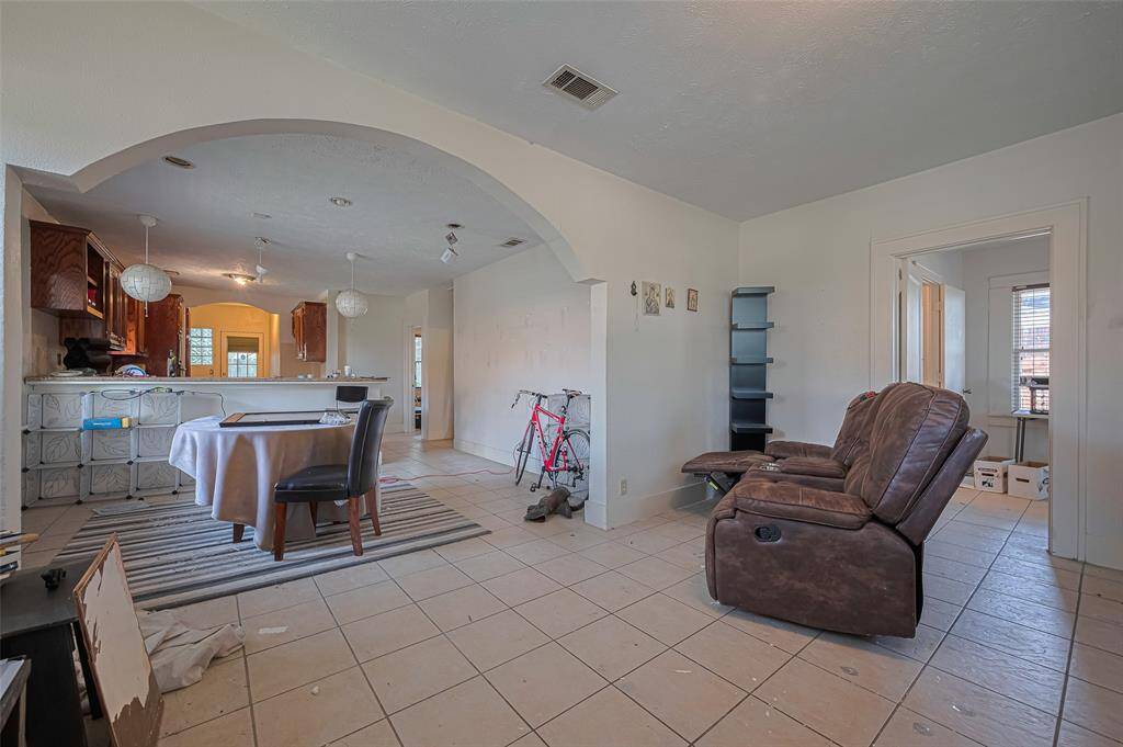 Living room has large character archway to dining and kitchen for open floor plan