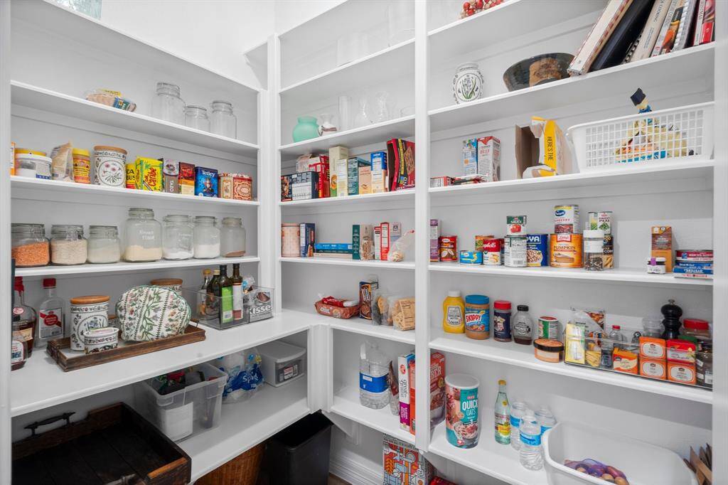 This spacious walk-in pantry offers ample shelving for all your kitchen essentials—food, appliances, glassware, and everything in between. Organized living starts here!