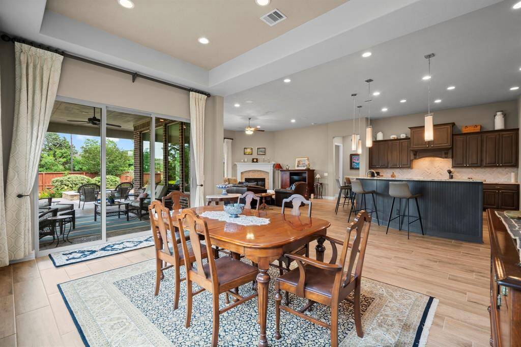 Gather your guests and celebrate in this stunning Dining Room, designed for both grandeur and comfort. With plenty of space for a large dining table and full furniture suite, this room is perfect for any special occasion. It features wood-look tile flooring, two walls of windows for natural light, and a tray ceiling with recessed lighting.