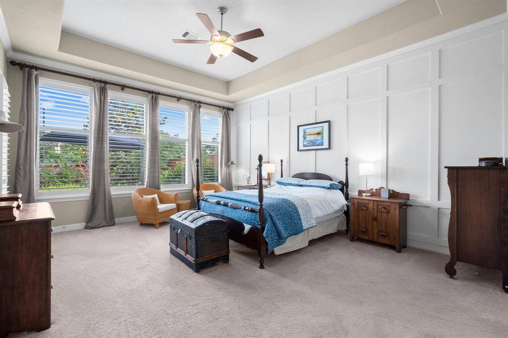Wake up each morning to serene views of nature in your private Owners’ retreat. Four large windows with plantation shutters flood the space with natural light and offer peaceful views of the pool, creating a tranquil atmosphere. There is also a private entrance from this room to the covered porch. With plenty of room for your favorite cozy furnishings, this spacious suite is the perfect place to relax and recharge.
