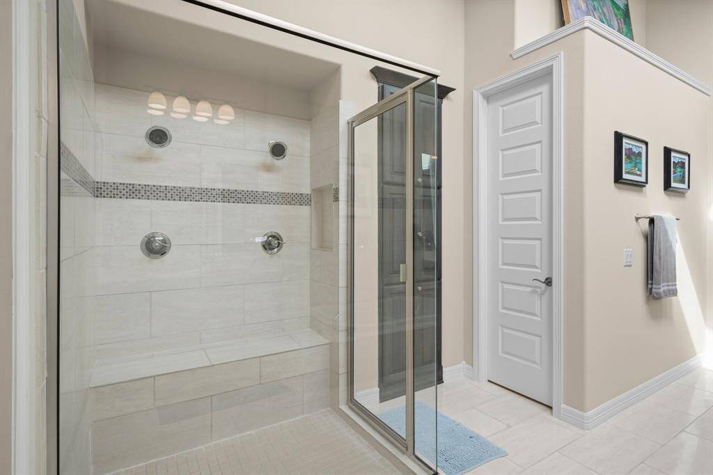 Unwind in the elegantly designed, spa-inspired Owners’ bath. Start your day refreshed with a spacious tiled shower featuring a large bench seat, dual shower heads, and built-in toiletry niche. In the evenings, sink into the soaking tub for the ultimate relaxation experience. The built-in linen cabinet holds all your linens and essentials.