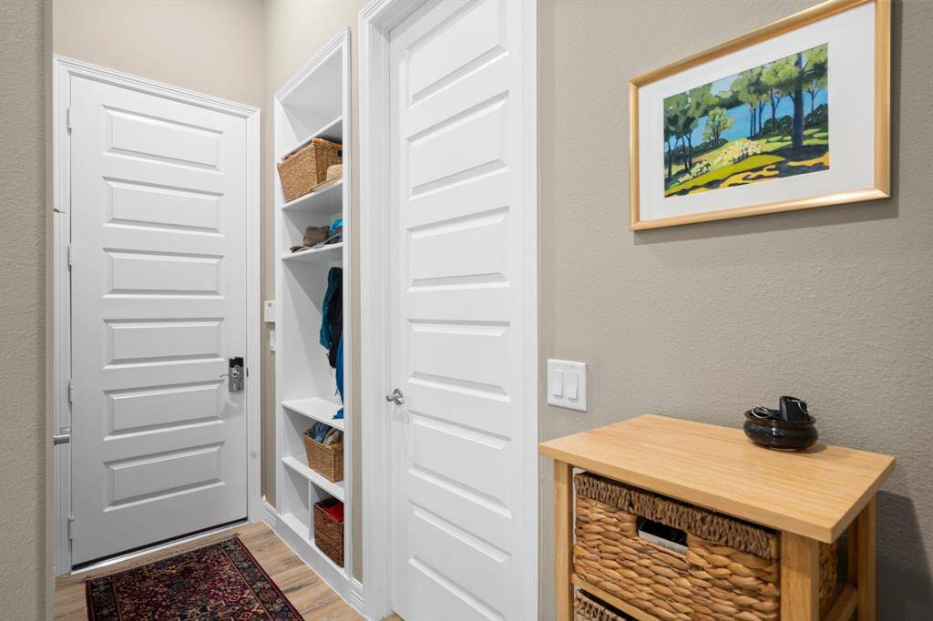 Keep everything in its place with this great organization cubby located off the garage entrance and laundry room featuring multiple shelves and cubbies for purses and shoes while also boasting hooks for coats or backpacks.