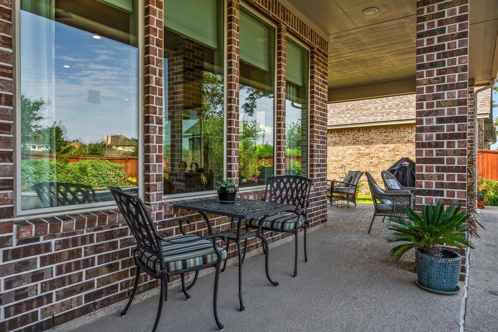 The other half of the covered porch is off the owner's suite and provides a shady place for morning coffee by the pool, or a quick place to sit after swimming to get out of the sun.