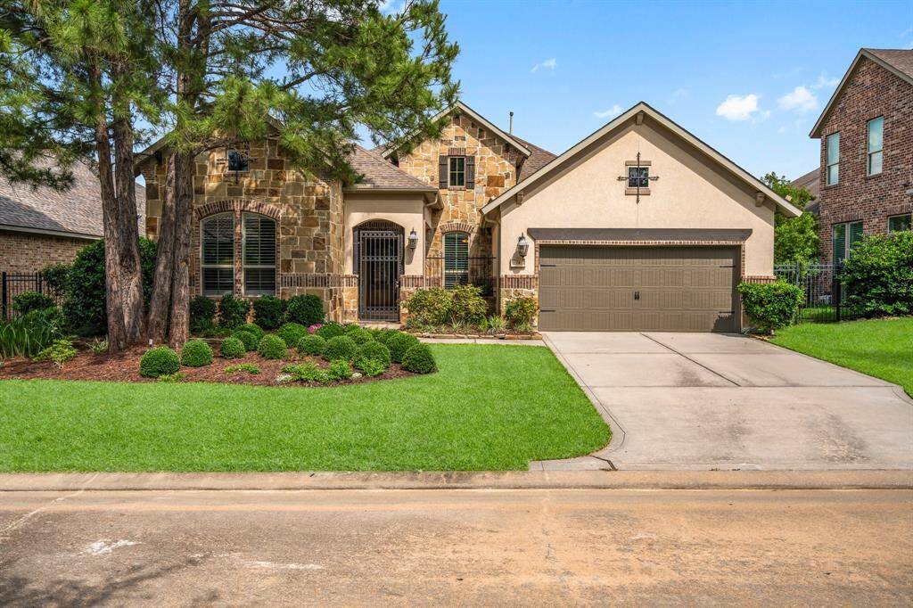 74 N Braided Branch Drive offers timeless charm and modern convenience. From the intricate brick and stone work, contrasting shutters, iron entry gate, and gorgeous landscaping with uplighting, every detail adds to its impressive curb appeal. Inside, you'll find breathtaking ceilings, crown molding, 8 foot doors throughout, and plenty of upgrades that make this home truly special.