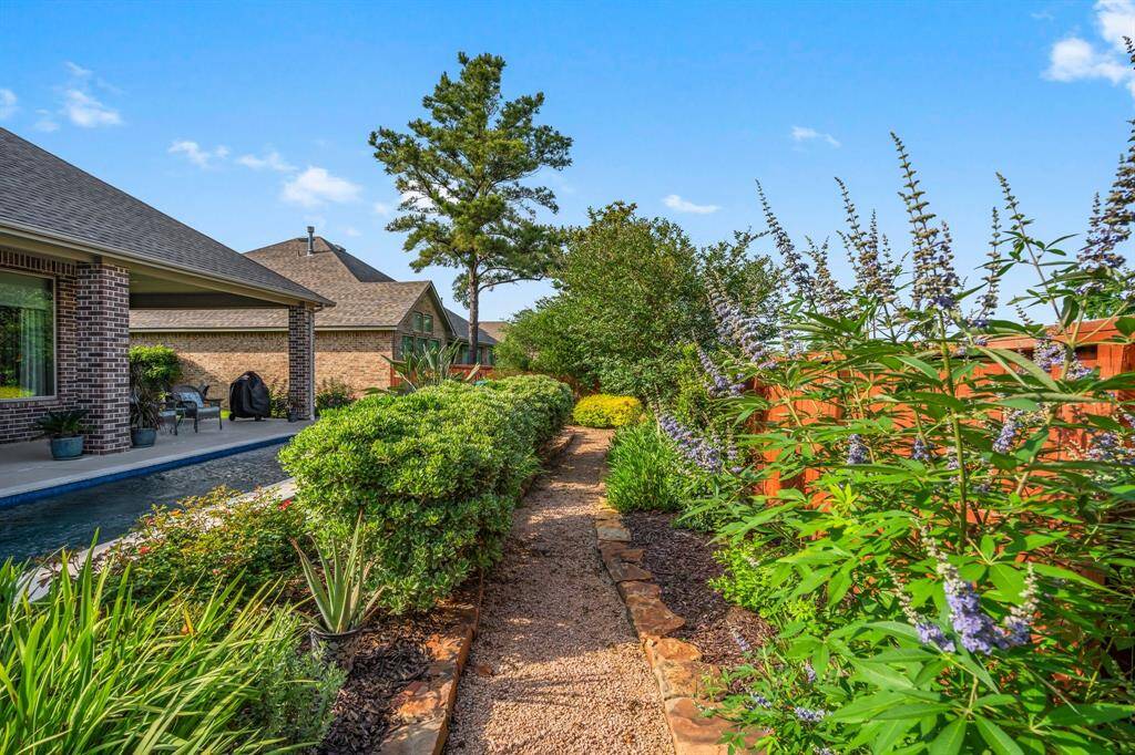 The landscaping is such a fabulous mix of lush and tropical yet has also kept to the southern roots of the area with blooming perennials. So well maintained and detailed with outdoor landscape lighting to add to the evening charm that this home provides!