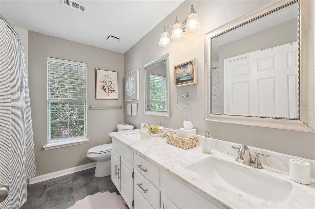 Guest bathroom upstairs with tub and shower combo.