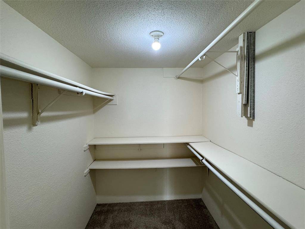 Primary bathroom with NEW shaker cabinets, granite tops, NEW plumbing and decorative mirror and lighting.