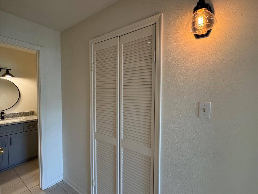 Laundry room with tons of shelving and connections on left