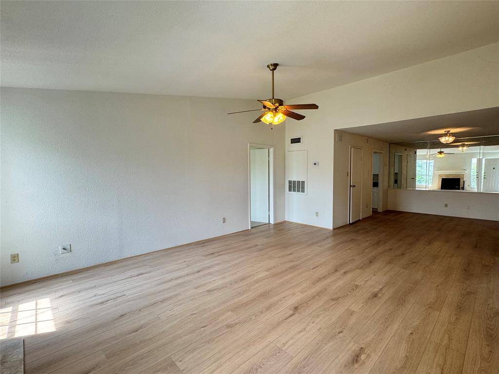NEW luxury vinyl plank throughout the living room, dining room, and kitchen provides a warm, inviting environment.