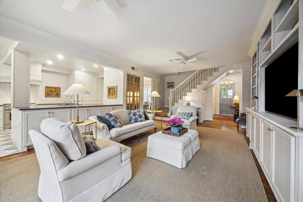 The generously sized family room opens to the kitchen and breakfast areas, as well as the dining room in the far back left of this photo. The entry foyer is in the far right.