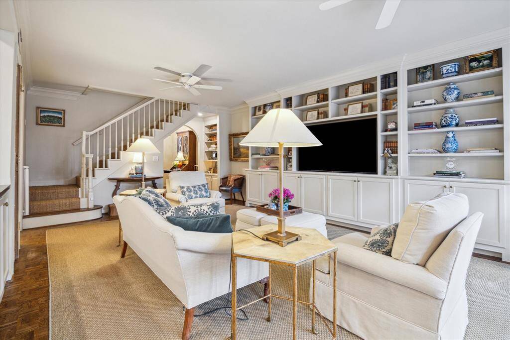This view of the family room showcases the built-ins providing attractive space for your TV, electronics, and decorative accessories.