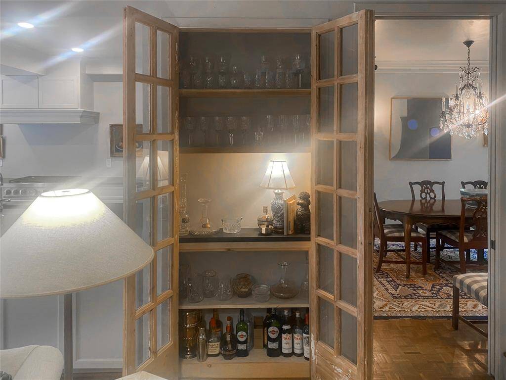 Look at this stunning family room surprise  ----  open shelving highlighted by antique paned doors.  Sellers use this pleasing space as a dry bar and crystal showcase.