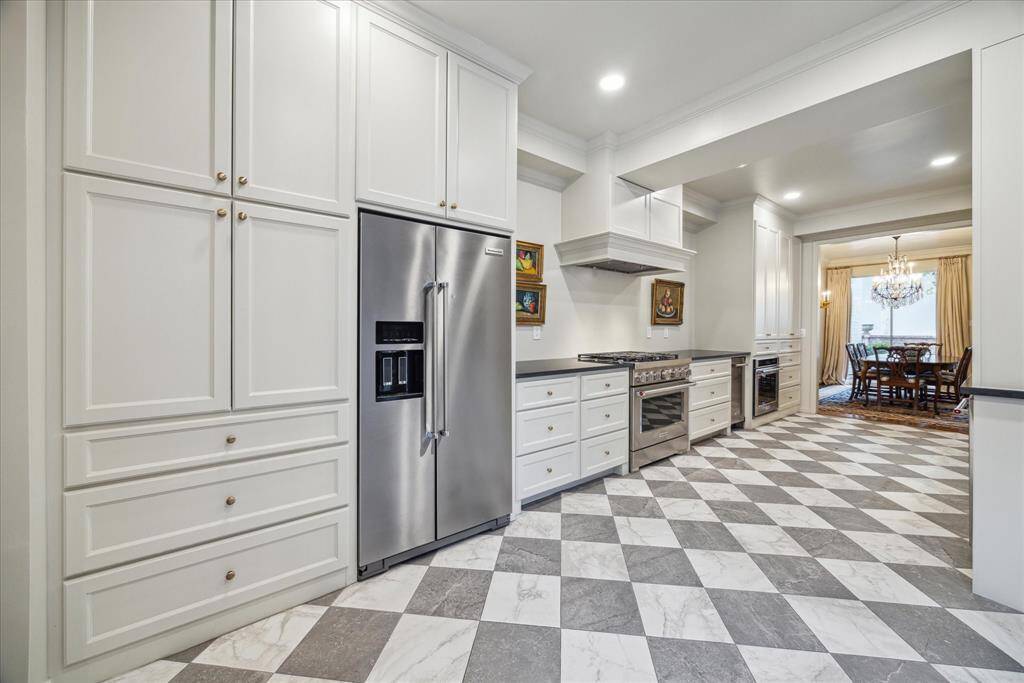 Extensively remodeled, this chef's kitchen is sure to wow!  The gorgeous new cabinetry offers so much storage and is highlighted by the Quartzite countertops and recent stainless appliances.