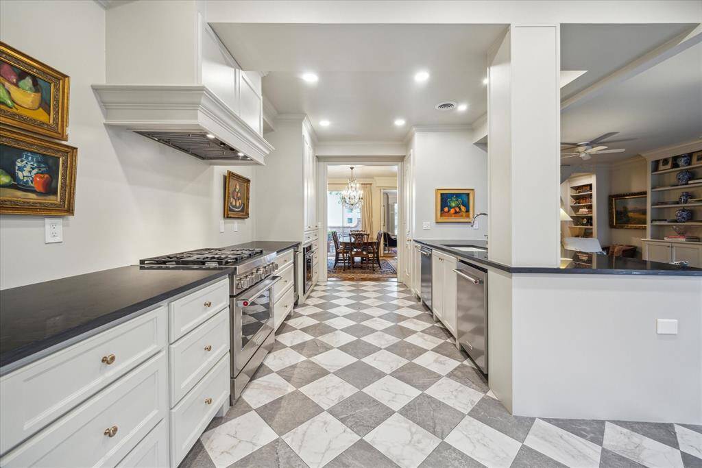 Again reminiscent of upscale New Orleans style, the Harlequin styled tile flooring is the perfect footprint for this updated kitchen.