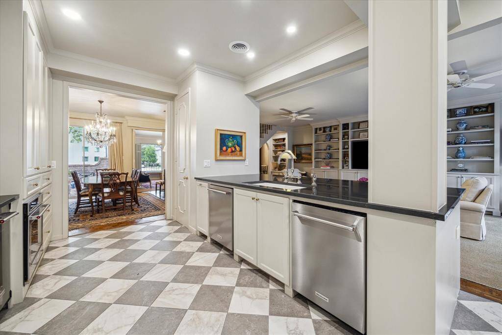 Positioned nicely between the formal dining and family rooms, the kitchen boasts TWO dishwashers, built-in range with gas burners, refrigerator, plus an ice maker.