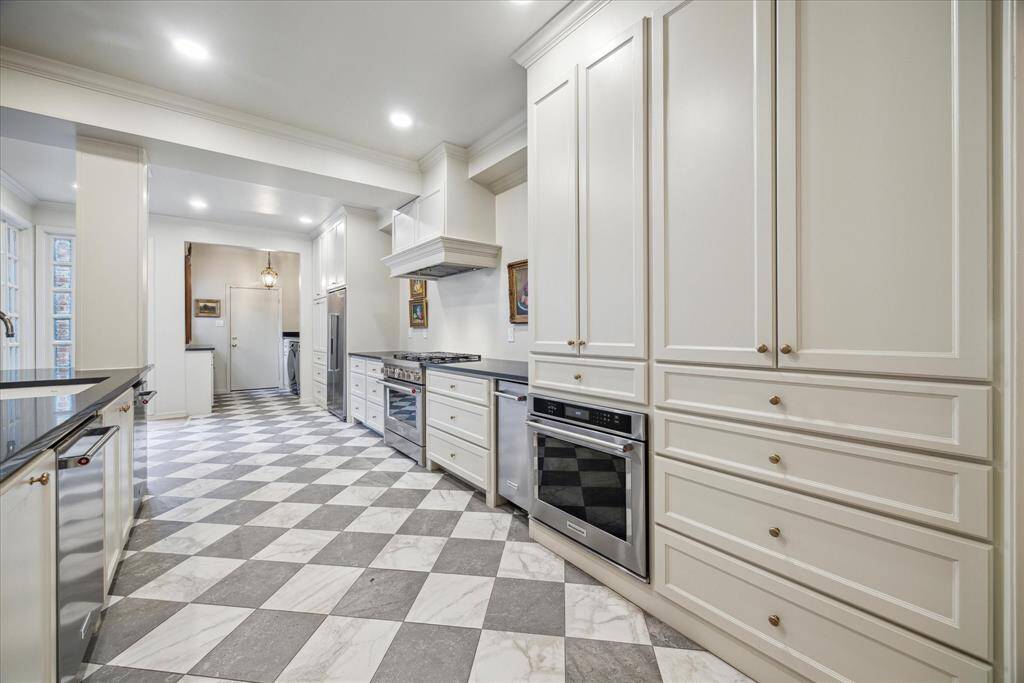 This view of the kitchen features the breakfast room space and Butler's Pantry/laundry room just beyond.  The door in the background opens to the two car garage.