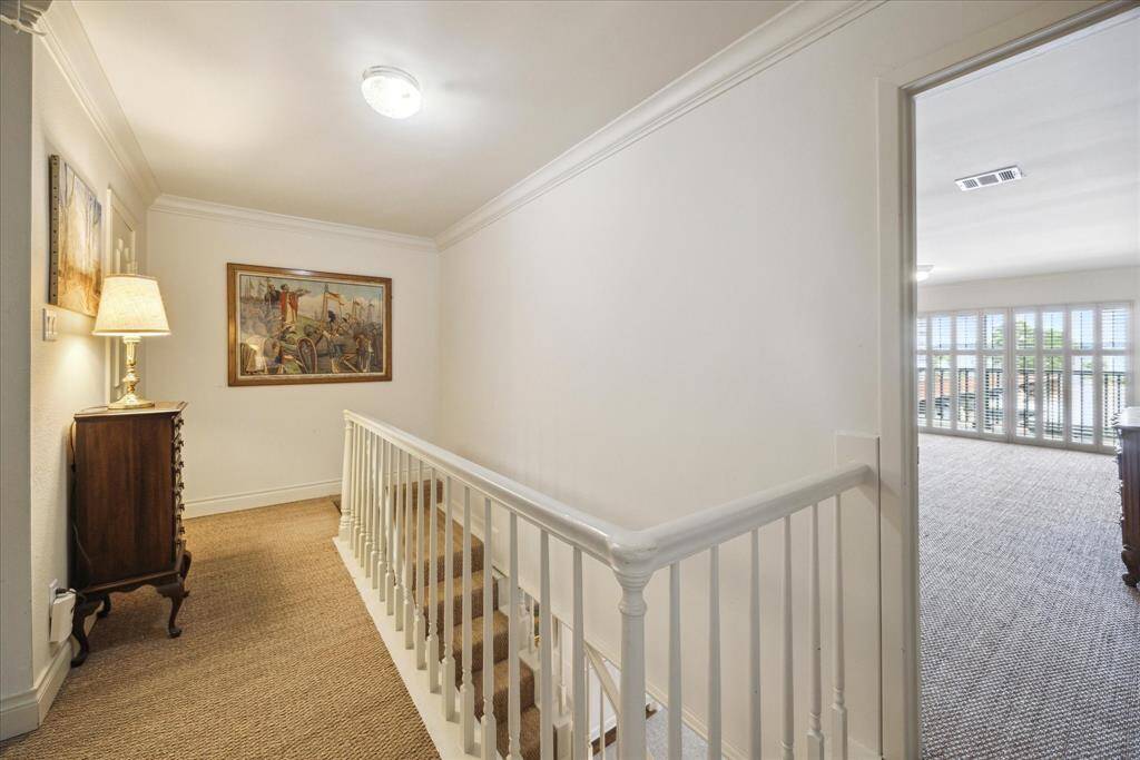 The landing of the second floor offers great space to highlight artwork and separates the primary suite from the secondary bedrooms.