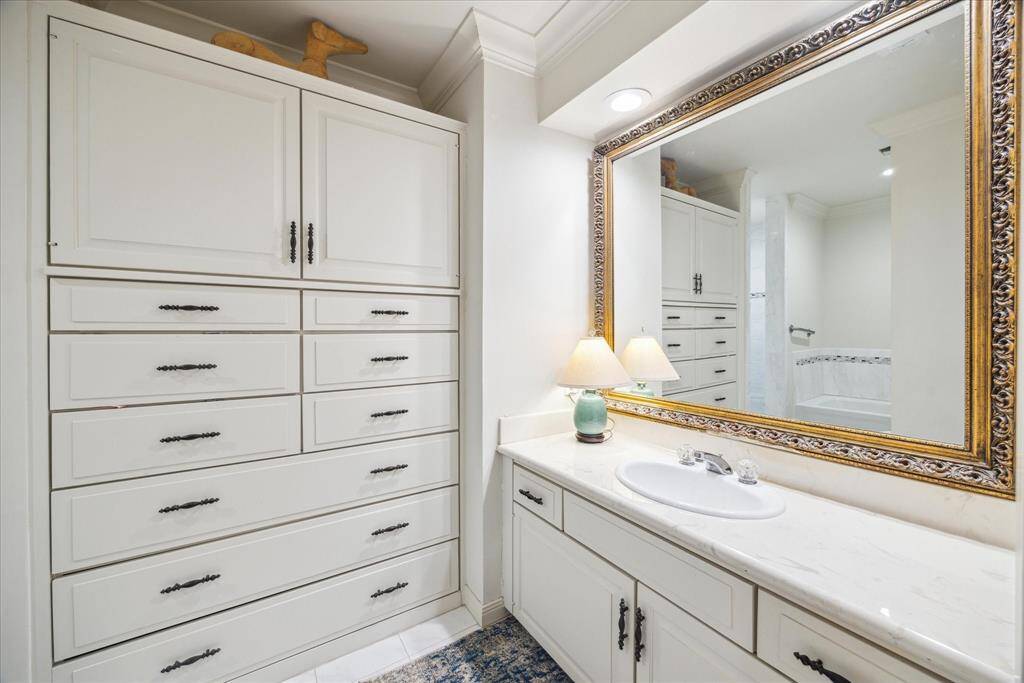 Features of the primary bathroom include this built-in wardrobe, tub and separate shower.