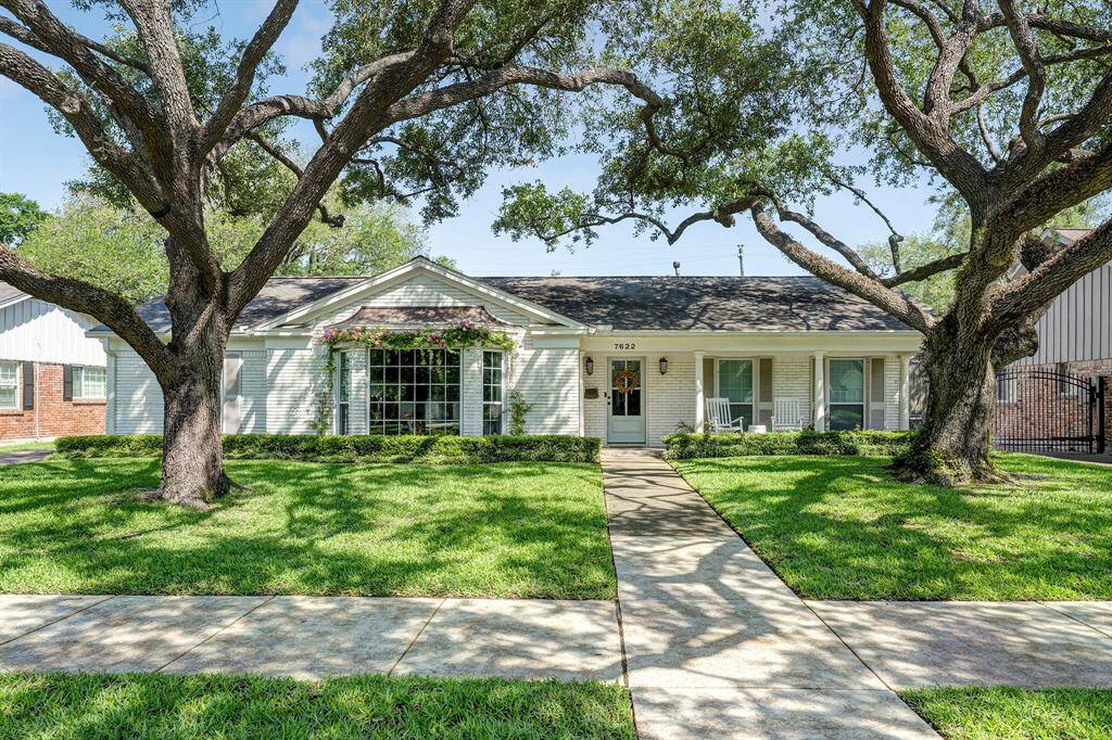 7622 Fairdale has charming curb appeal and is nestled beneath two majestic live oaks in the heart of Briarmeadow.