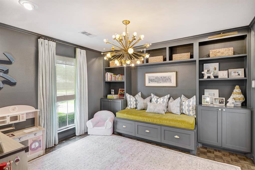 The breakfast room is ideal for casual meals, featuring a dry bar with a wine fridge and a built-in shelf for storing cookbooks and kitchen essentials.