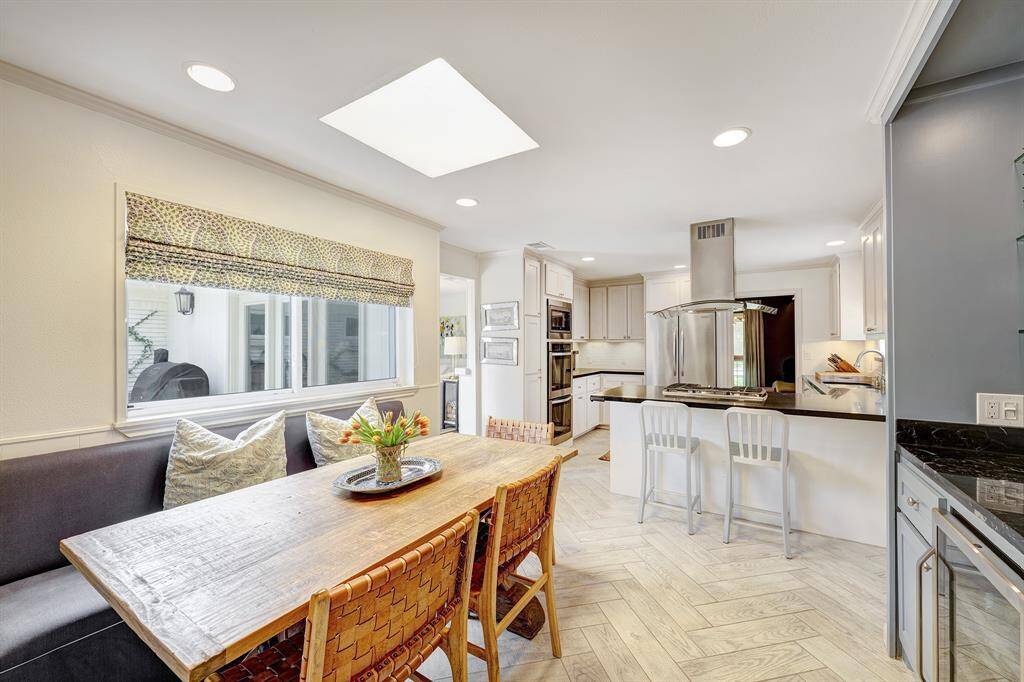The kitchen is open to the breakfast room and features a countertop seating area.