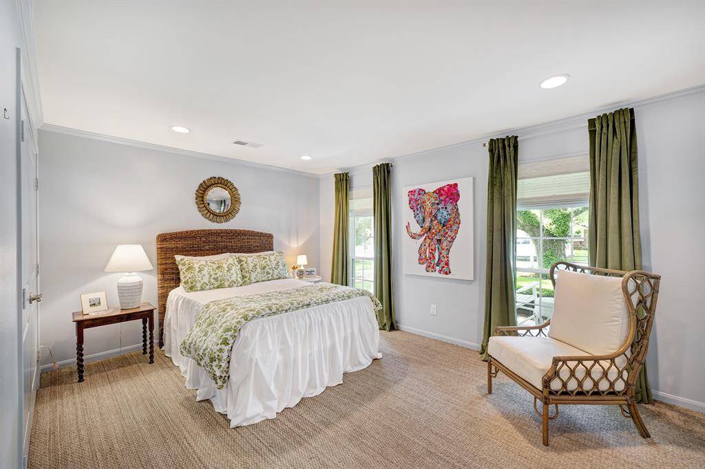 Secondary front bedroom with two large windows, offering views of the front porch and yard.