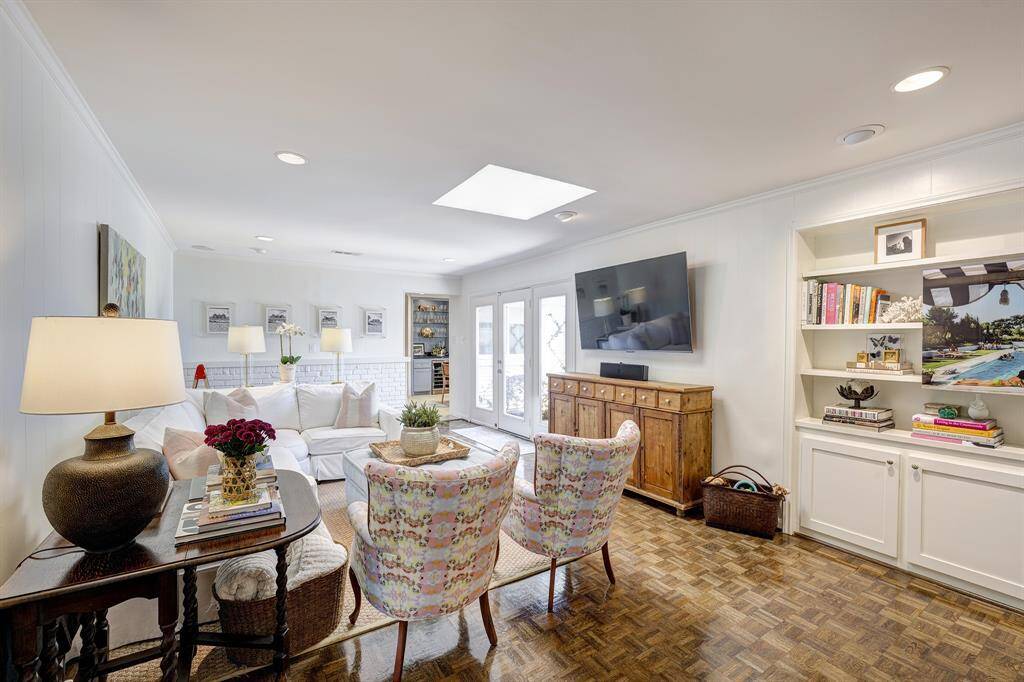 Just off the entry, you'll find a large family room with parquet floors and plenty of room for flexible furniture arrangements.