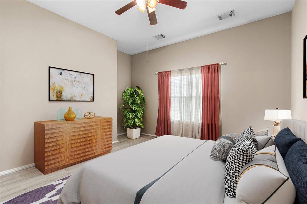 The primary bedroom with en-suite bath is ideally located at the rear of the home for maximum privacy and views of the backyard.