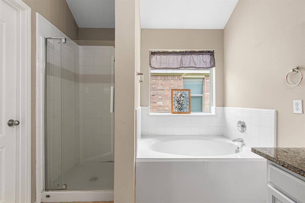 The primary bath features a soaking tub and separate shower.