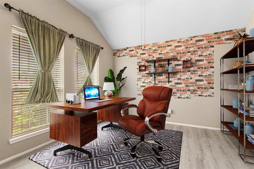 Dedicated home office/study is conveniently located at the front of the home, with views to the front yard. The brick accent wall is peel-and-stick, and can be removed at the request of a Buyer. This room would also make a perfect den or playroom.