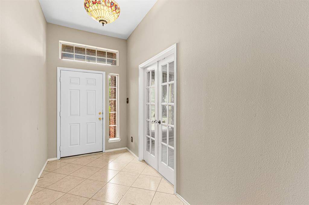 French doors from the entryway lead into the home office/den.