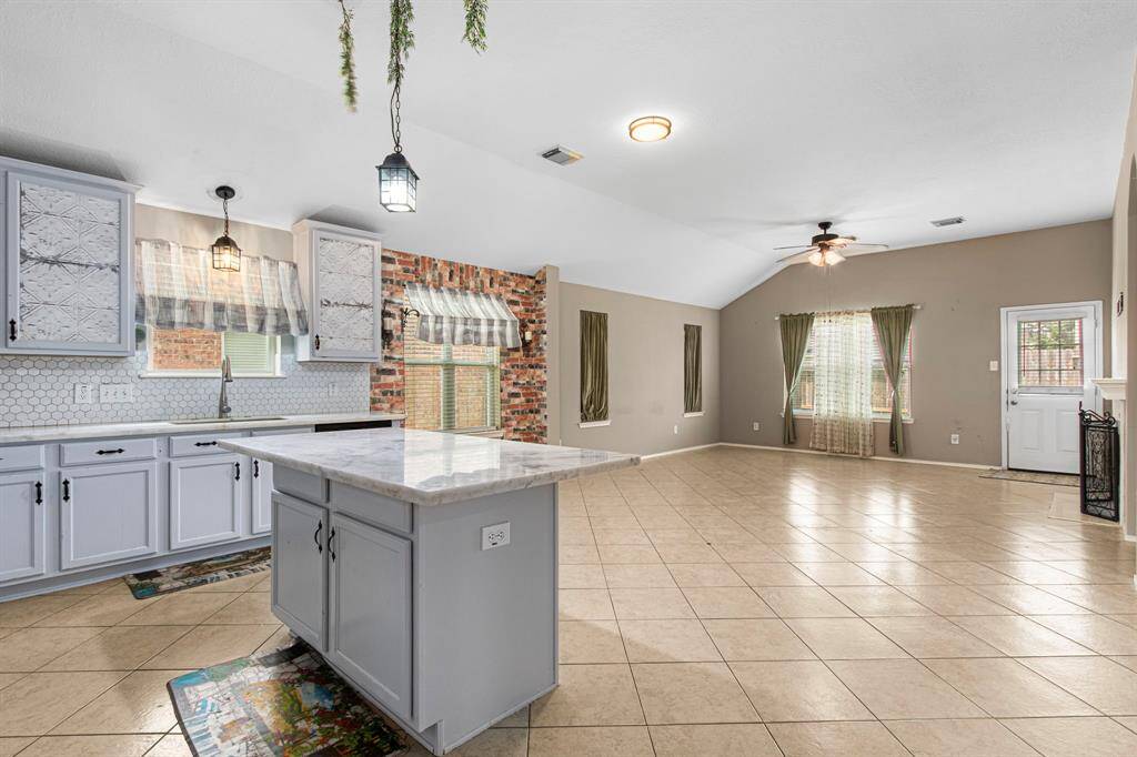 View to the family room. All of the home's curtains have been removed for window/blind cleaning. They can be left at the property for the new owner if requested.
